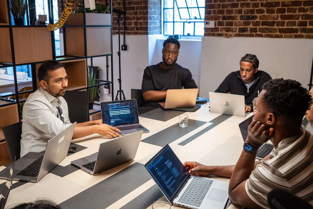 Small group discussing code during the AI agents workshop